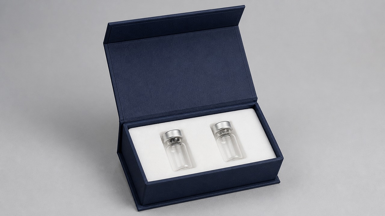 Open navy custom two-slot 3 ml vial case with two clear glass vials in a white foam insert